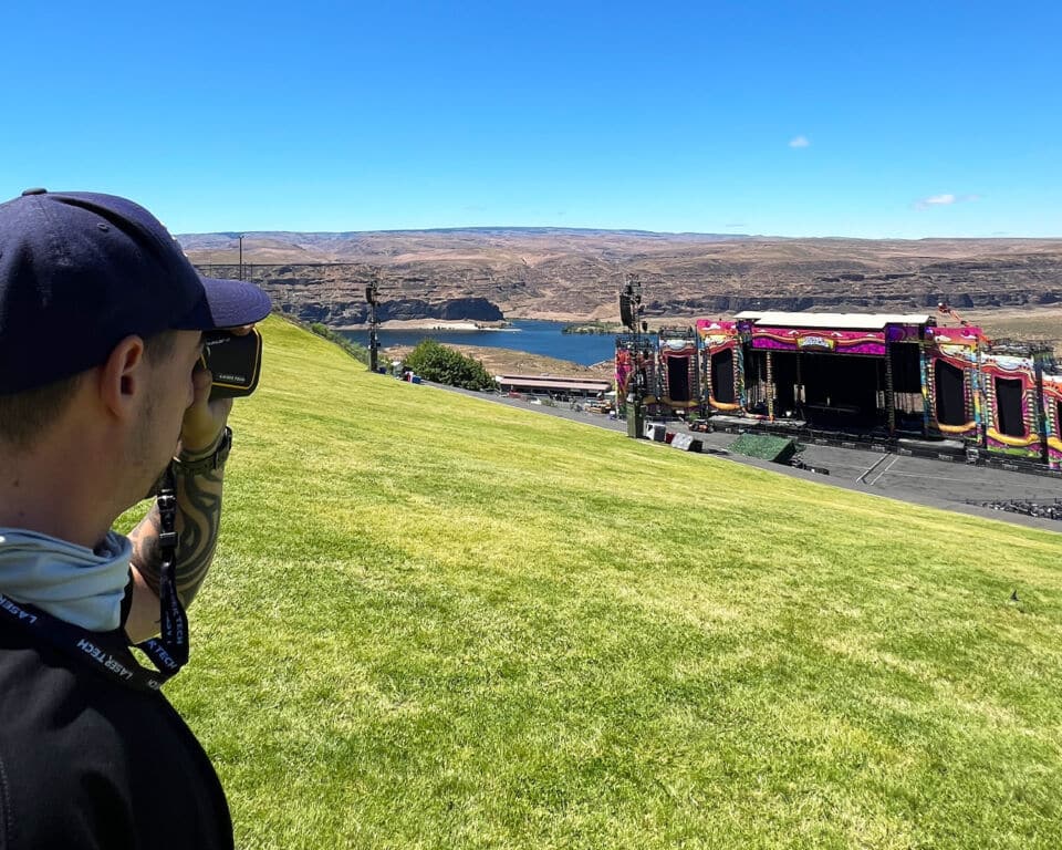 Aaron Zuber uses a TruPulse L2 Rangefinder for audio engineering measurements at Beyond Wonderland